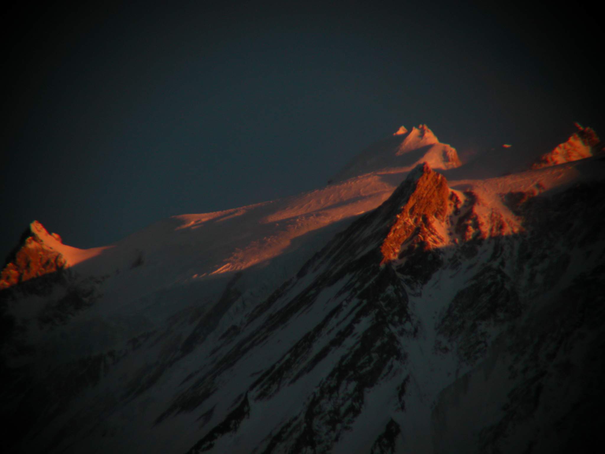 Manaslu 09 11 Manaslu Summit Plateau Close Up At Sunset From Bimtang Here�s another extremely close up view from Bimtang at sunset of the summit plateau of Manaslu with the East Pinnacle (7992m) on the left and the summit to the right.